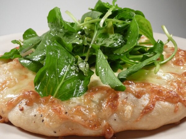 white pizza with arugula